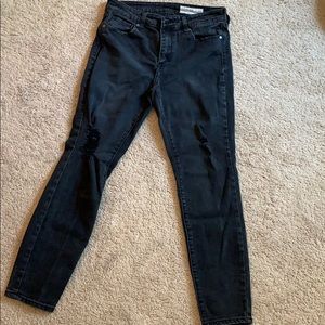 Women’s black jeans with some distress